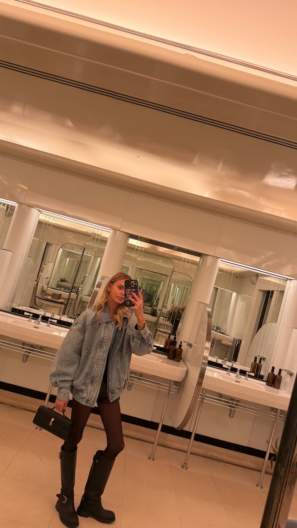 Saint Laurent denim jacket Norma Kamali leather shorts savette bag dolce boots 