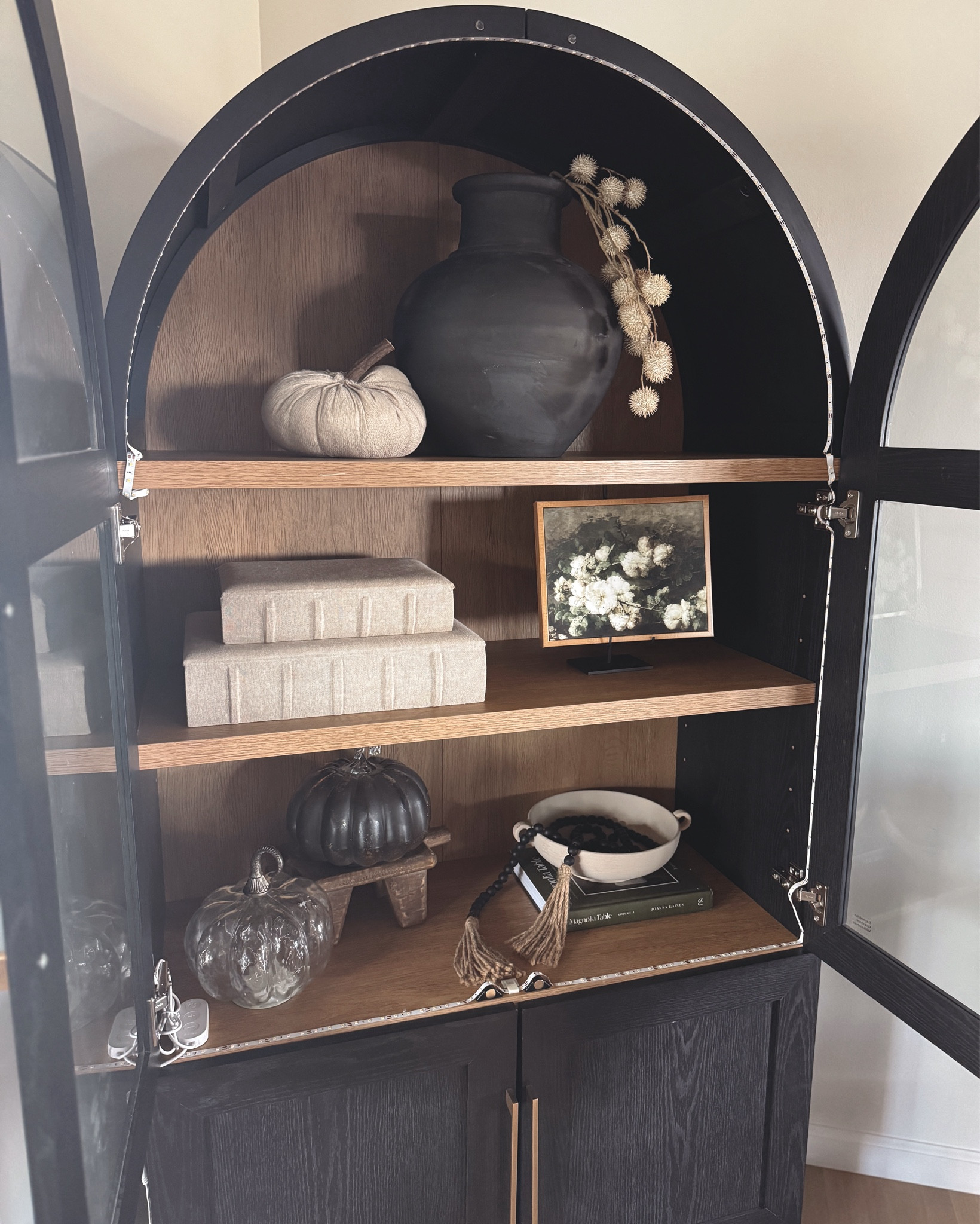 Neutral fall arch cabinet styling 🍂🖤 Layered art, cozy pumpkins, and textured ceramics for that collected look. Linking similar cabinet styling pieces + seasonal finds.
#LTKhome #CabinetDecor #FallHomeInspo
