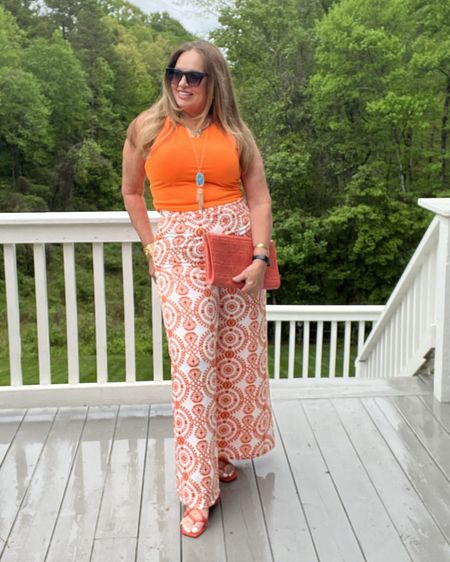 Citrus hues hit different 🧡🧡🧡. Love the easy vibe of printed palazzo pants my tank is my go to layer in the Summer and I own it in several vibrant colors. My lace sandals were a fun find for Summer✨🎶. 

#LTKparties #LTKover40 #LTKtravel