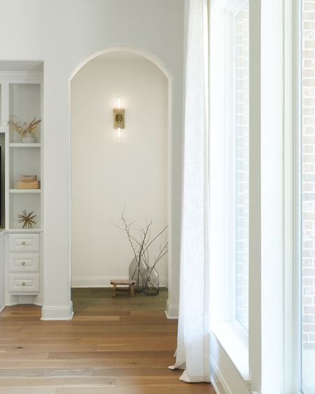 LIGHTING ✨ | Fresh white paint and a simple sconce add so much character to this small hallway! 

✨Paint: SW Alabaster
✨Flooring: The Masters Craft, Harroway
✨Link in bio for product sources and ideas

#sconce #hallway #lighting #branches #vases #decorative stool #remodel #home updates