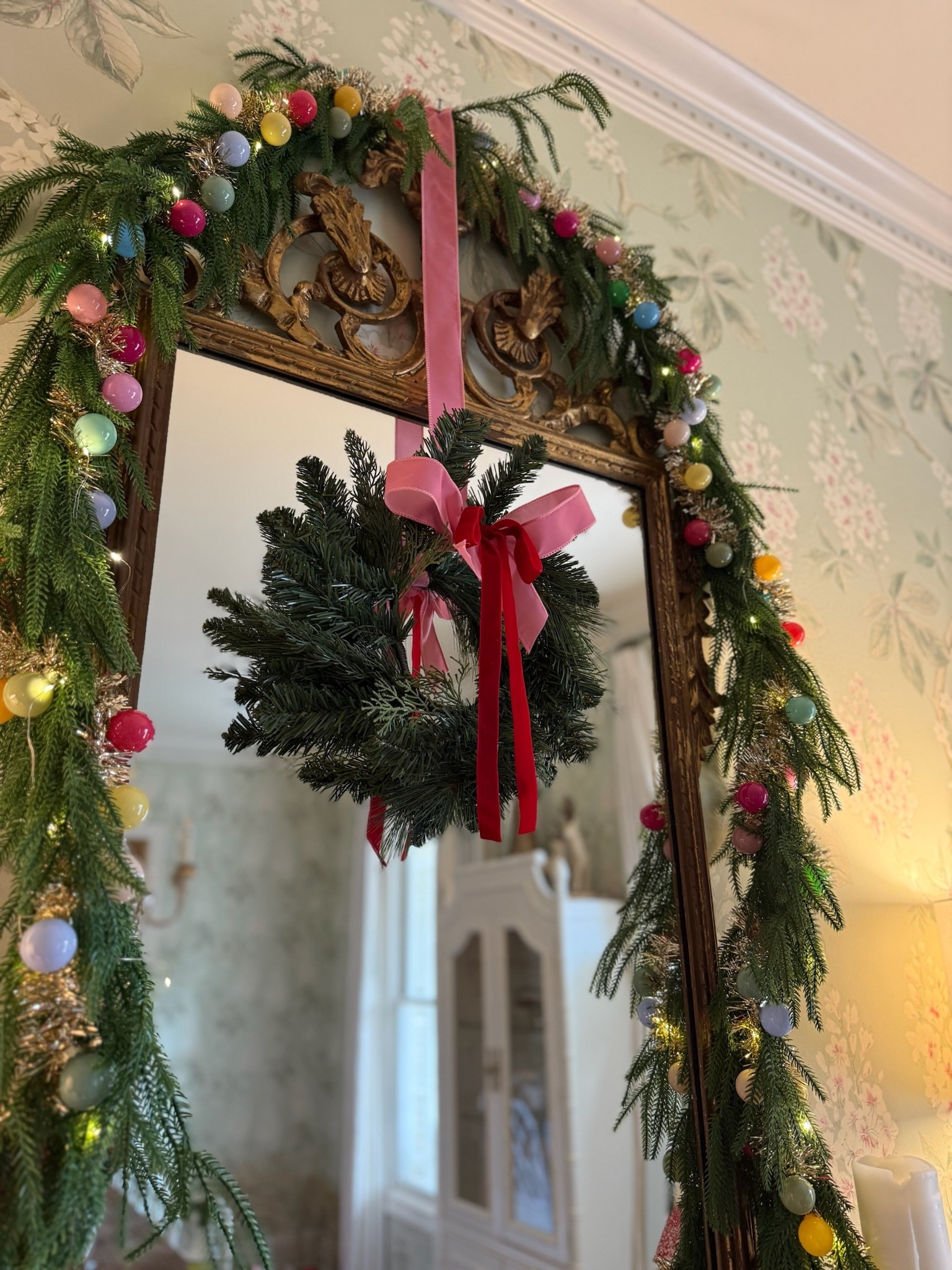 Such a fun way to decorate a mirror for Christmas! Mini wreath and garland! 

#LTKHome #LTKHoliday #LTKSeasonal