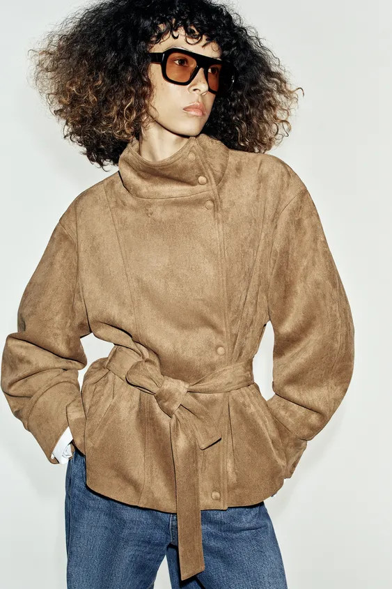 High-neck jacket with long sleeves. Front pockets. Features a matching fabric belt and gathered d... | Zara UK