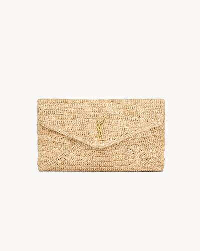 large envelope pouch with flap in natural woven raffia, decorated with the CASSANDRE. | Saint Laurent Inc. (Global)