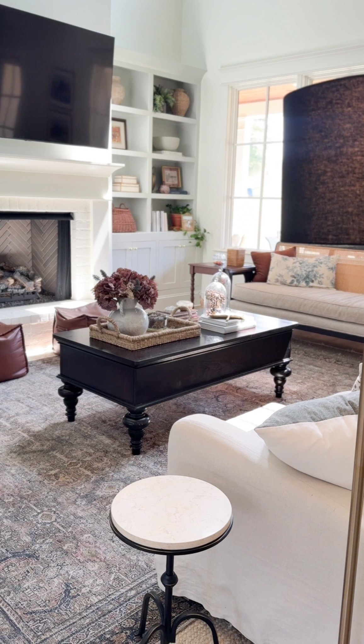 Living room view ✨ I’ve been slowly swapping things out for fall, and recently gave our coffee table a little refresh. I added some moody fall stems from Hobby Lobby and tucked a few seasonal touches into my glass cloches. This year I’m leaning into plum and blue tones for fall, and I’m loving the cozy yet fresh vibe they bring to the space. 🍂💙

#LTKSeasonal #LTKHome