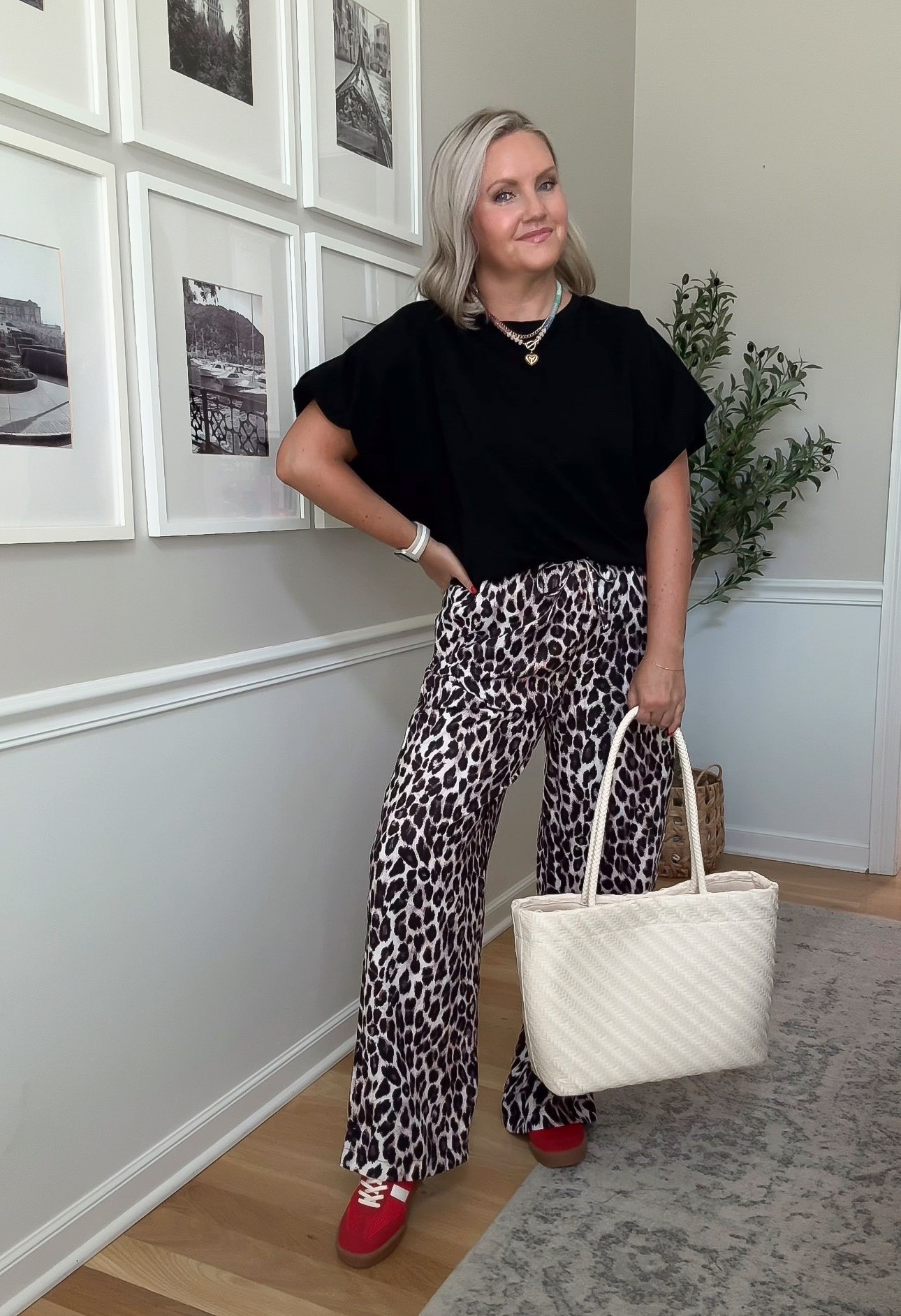 I wanted to let the leopard pants be the whole moment, so I kept everything else simple with a soft black top and neutral tote. The wide leg fit drapes instead of clinging, and the red sneakers add a fun pop that keeps the outfit from feeling too serious.

leopard print pants, wide leg pants, black top outfit, casual work style, statement pants, red sneakers, comfortable outfit, everyday fashion, fall transition look, lovelylifestyling

#LTKootd #LTKSeasonal #LTKOver40