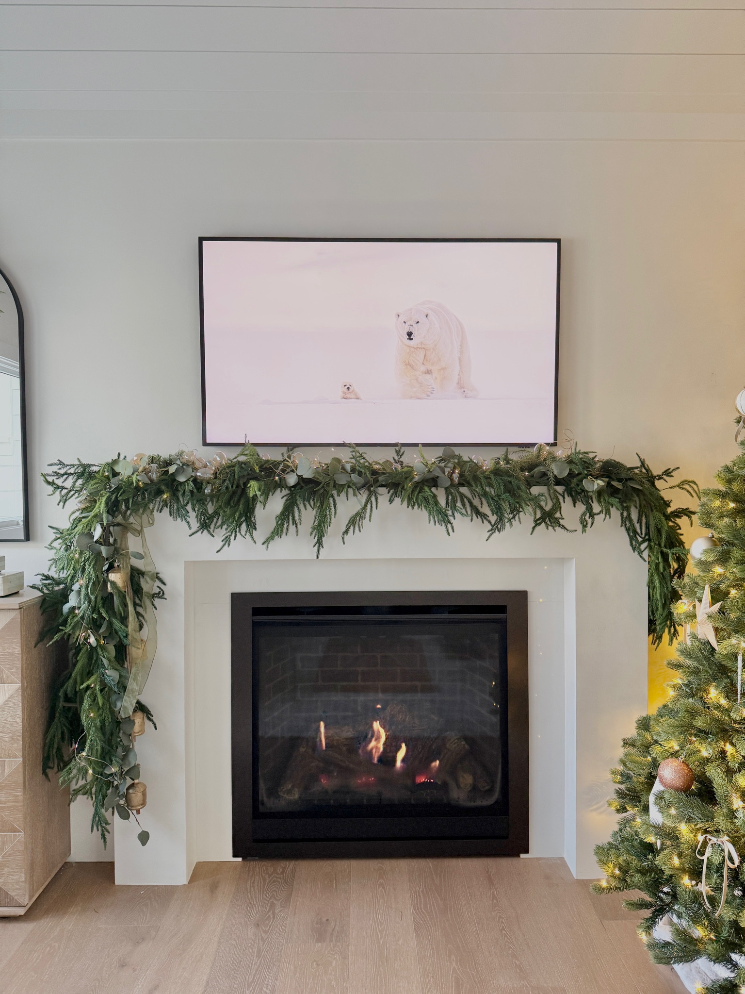 Let’s Style Your Mantle for the Holidays! 🤍

Styling your mantle can be challenging! This year, I went for a natural, elevated look to contrast my sleek white fireplace. By layering different textures and adding fairy lights, your mantle will be sparkling in no time! ✨

HOW TO:
- Install command hooks across the mantle. I chose to place two on top and one larger on the front face!
- Layer and wrap 3 Norfolk Pine garland and 2 eucalyptus garlands. You can adjust the quantity to the size of your mantle, the fuller the better!
- Twist in 2 cases of fairy lights. I found these on sale at Target for $3.50!
- Add some finishing touches! I inserted a handful of curly twigs, vintage bells tied with green tulle ribbon and my favorite opalescent glass bobbles!

#LTKSeasonal #LTKHome #LTKHoliday