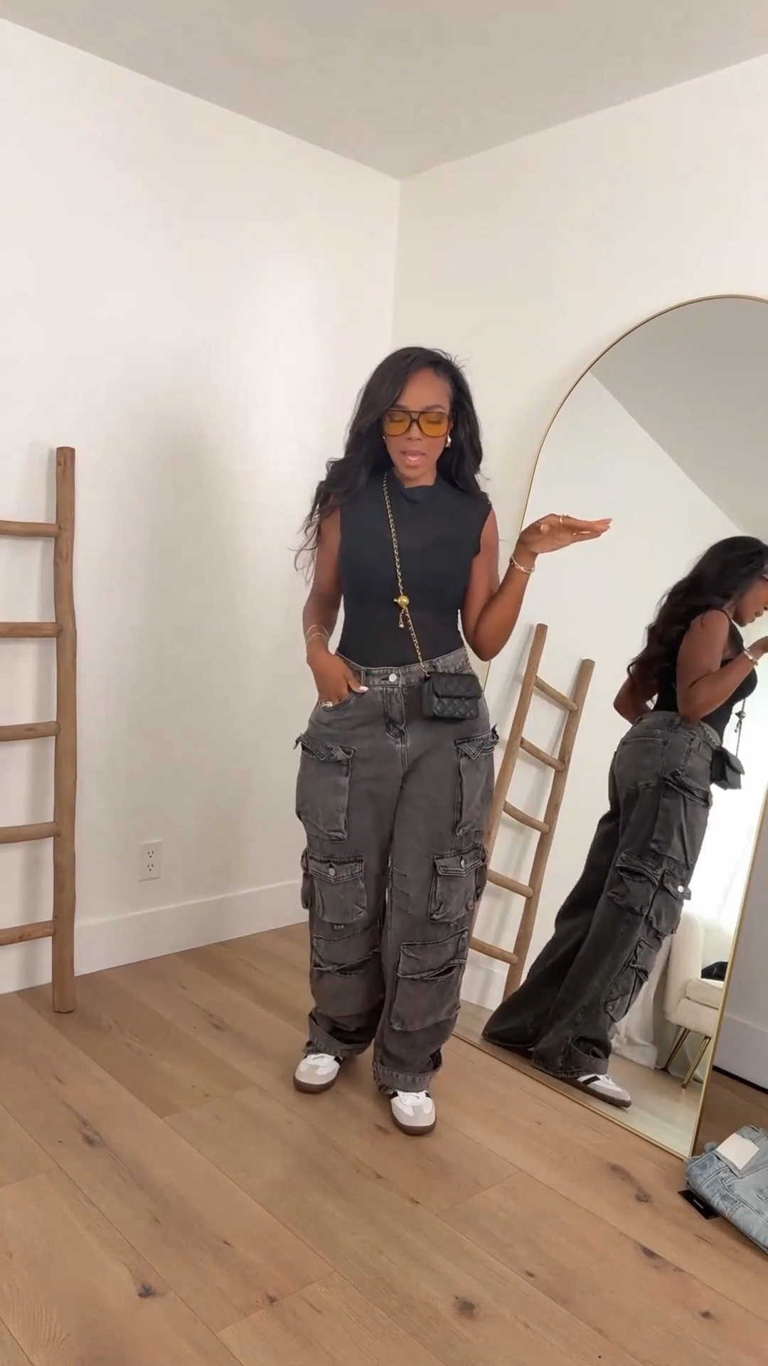 ✨ Concert Cargo Cool — Edgy yet laid-back, this look pairs oversized cargo pants with a sleek sleeveless top, crossbody mini bag, and statement shades. Sneakers finish it off for comfort and style.

Perfect for concerts, streetwear days, and casual weekend outings.

