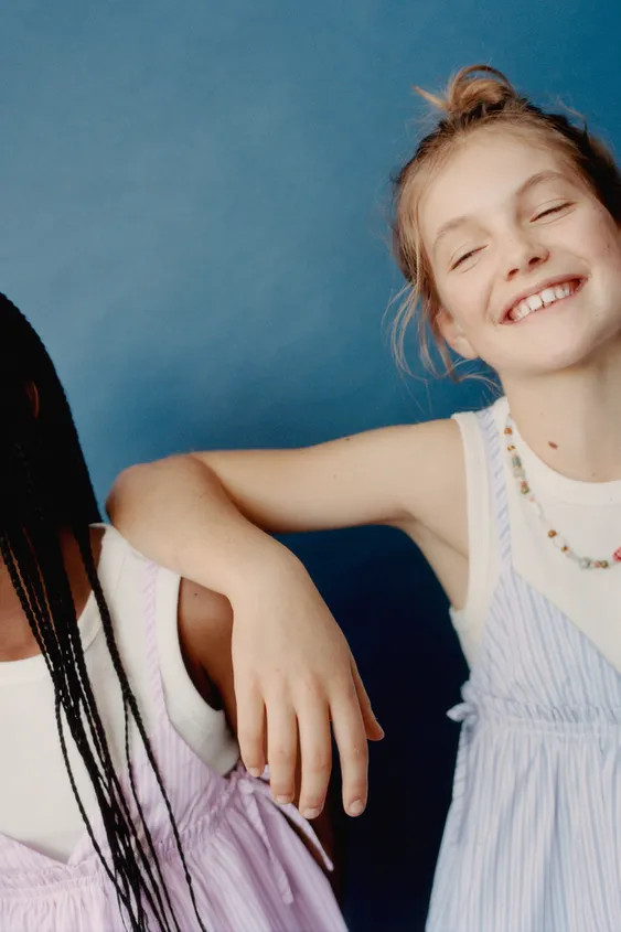 V-neck top with straps. Featuring bows on the sides and a stripe print. Inner rib T-shirt with a ... | Zara UK