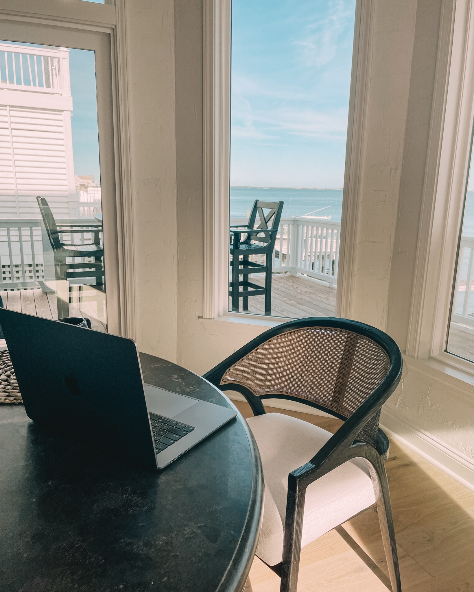 Working from the breakfast nook.

These gorgeous black/tan rattan chairs are so comfy and pair so well with the table for a comfy cozy mix-and-match look. 

I’m obsessed with how comfy these chairs are from Arhaus. #BeachHouse #DiningRoom #Perigold #Arhaus 

#LTKHome #LTKSaleAlert