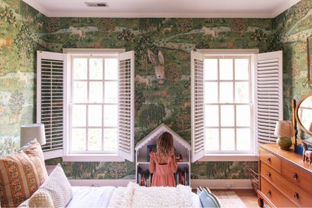 Polly’s walls are covered in the prettiest scenic wallpaper, which I don't want to cover up at all, and there's not much room on either side of the windows for curtains anyway. Plus, I really like how the white shutters add some charm to the space. 

#LTKkids #LTKhome #LTKstyletip