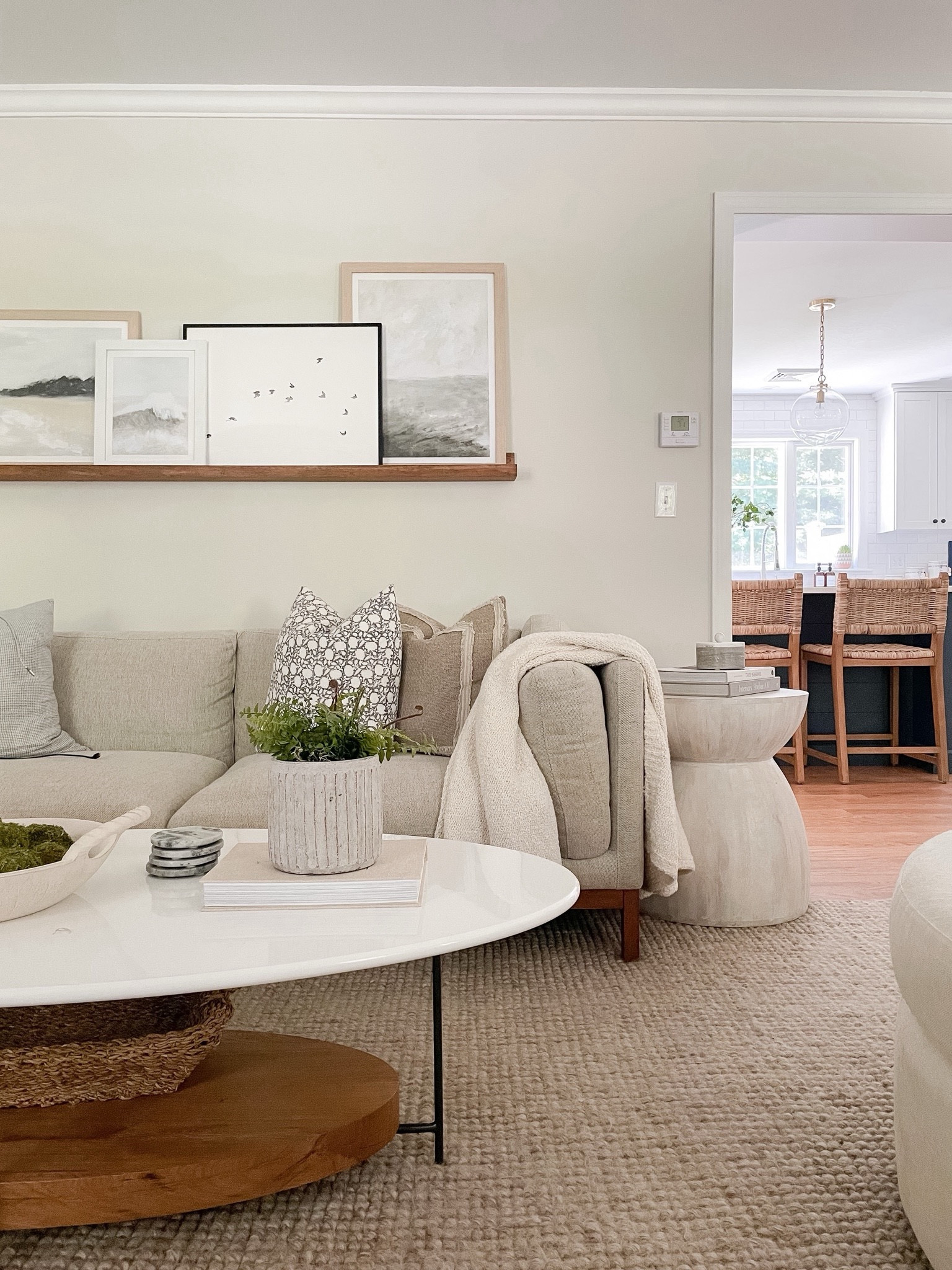 Modern coastal living room, Anthropologie side table, coffee table, Pottery Barn rug, gallery frames, swivel accent chair, media console, faux tree

#LTKFindsUnder50 #LTKHome #LTKStyleTip