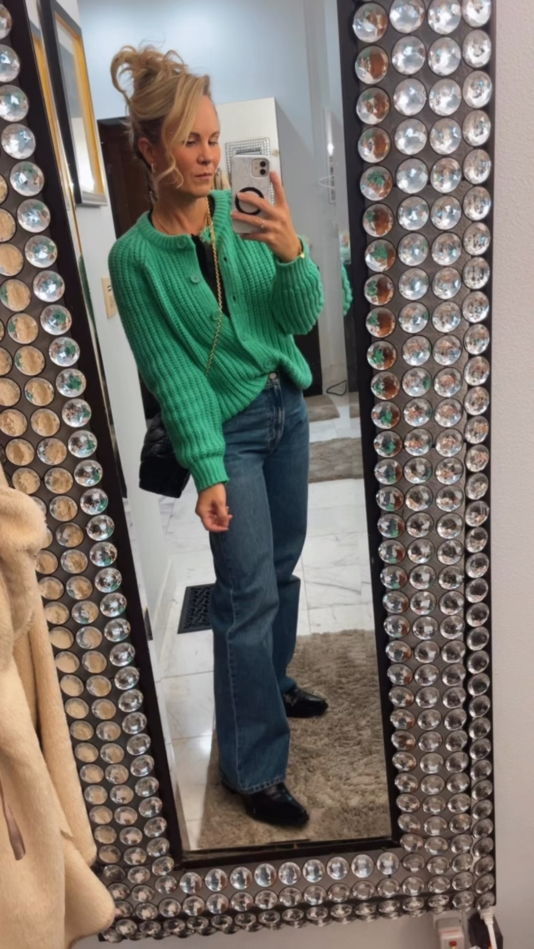 How cute is this green cardigan especially for the holidays I have it in red as well. It is a designer look-alike. Sezane has something similar to it and it is stunning- this is a much better price for sure. Paired with a black Henley that’s under $10 super comfortable and then my new favorite pair of jeans. These are so cute. These are Aritzia and I absolutely love them. They’re incredibly comfortable great casual piece to add to any wardrobe outfit. This is my holiday look for the night threw on my little Dior bag and my new black cowgirl boots and I’m set to go

#LTKHoliday #LTKmorningroutine #LTKgrwm