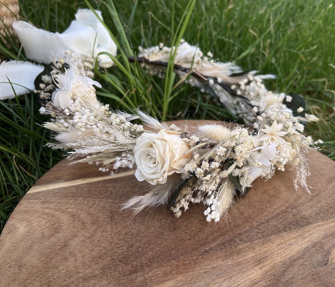 The perfect boho finishing touch 🤍 This white dried flower crown from breezeaccessory is handcrafted with real preserved roses, baby’s breath, eucalyptus, and soft ivory florals for a timeless, romantic look. Designed with a flexible wreath and adjustable ribbon tie, it’s comfortable to wear and beautifully suited for brides, flower girls, or bridesmaids. Ideal for weddings, baby showers, and photo shoots—and gift wrapping is available for an extra-special presentation. 🌿✨ #LTKwedding #BohoBride #FlowerCrown #DriedFlowers #EtsyWedding #BridalAccessories #RomanticDetails

#LTKGiftGuide #LTKWedding #LTKSeasonal