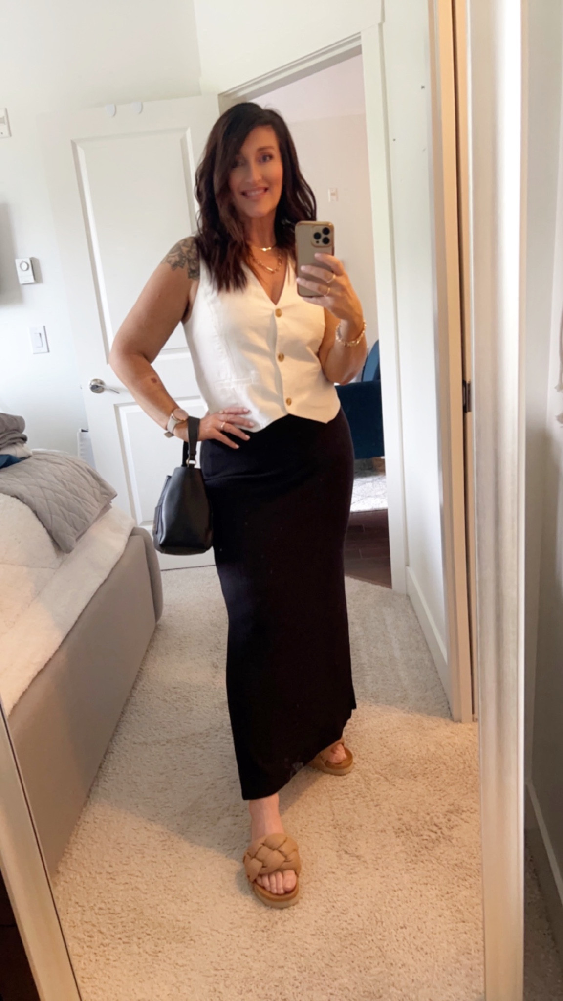 OOTD. I’m wearing a medium in the vest and skirt. Skirt is from Reitmans, so I can’t link it on here. My purse is sold out but found a similar Steve Madden one. I’m also baking in self tan foam from Bondi Sands, I love their tanning mitts  