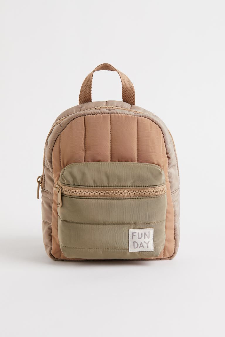Quilted, padded backpack in a woven fabric. Adjustable shoulder straps, zipper and hanger loop at... | H&M (US)