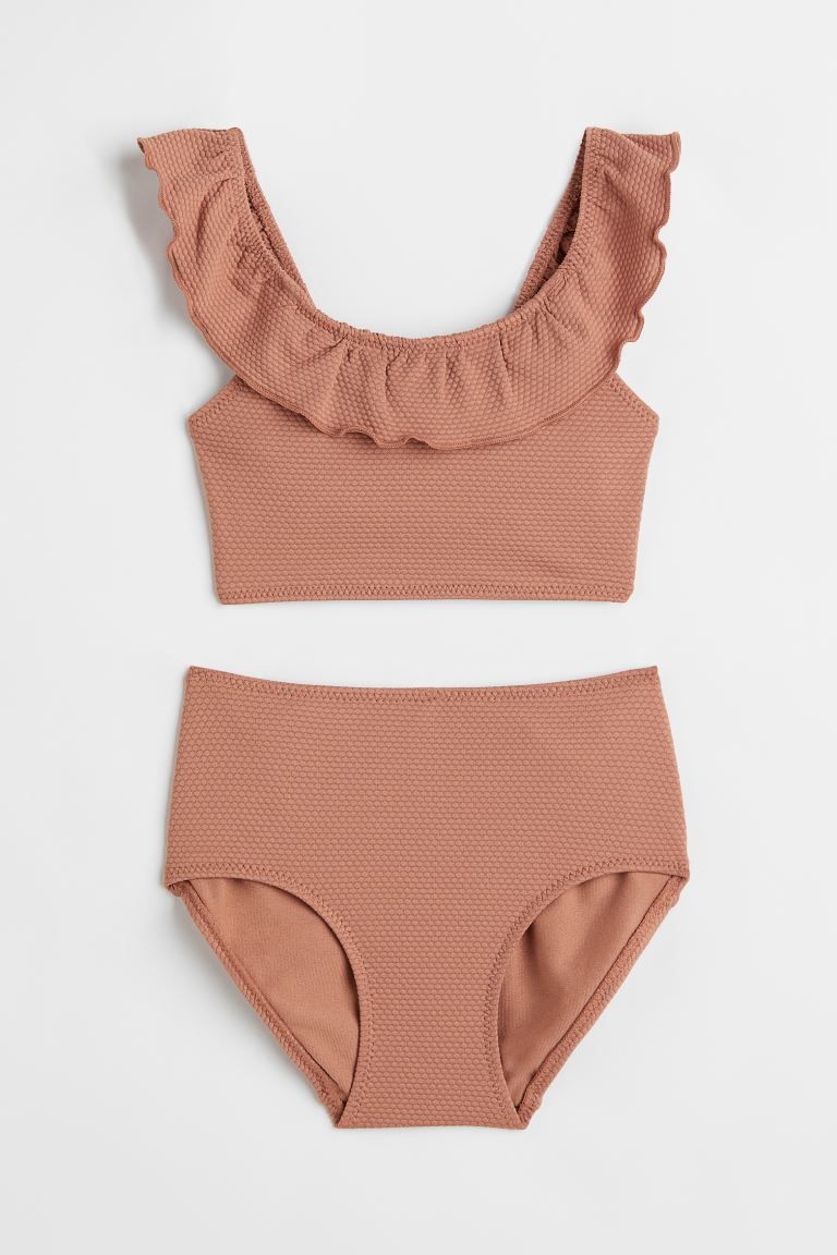 Conscious choice  Kids Exclusive. Fully lined, textured bikini. Top with an overlocked flounce at... | H&M (US + CA)