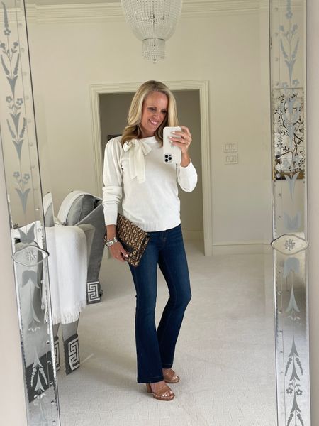 Casual Holiday Look: White sweater with bow detail, Spanx flare jeans, brown heels, Dior clutch

#LTKstyletip #LTKHoliday #LTKSeasonal