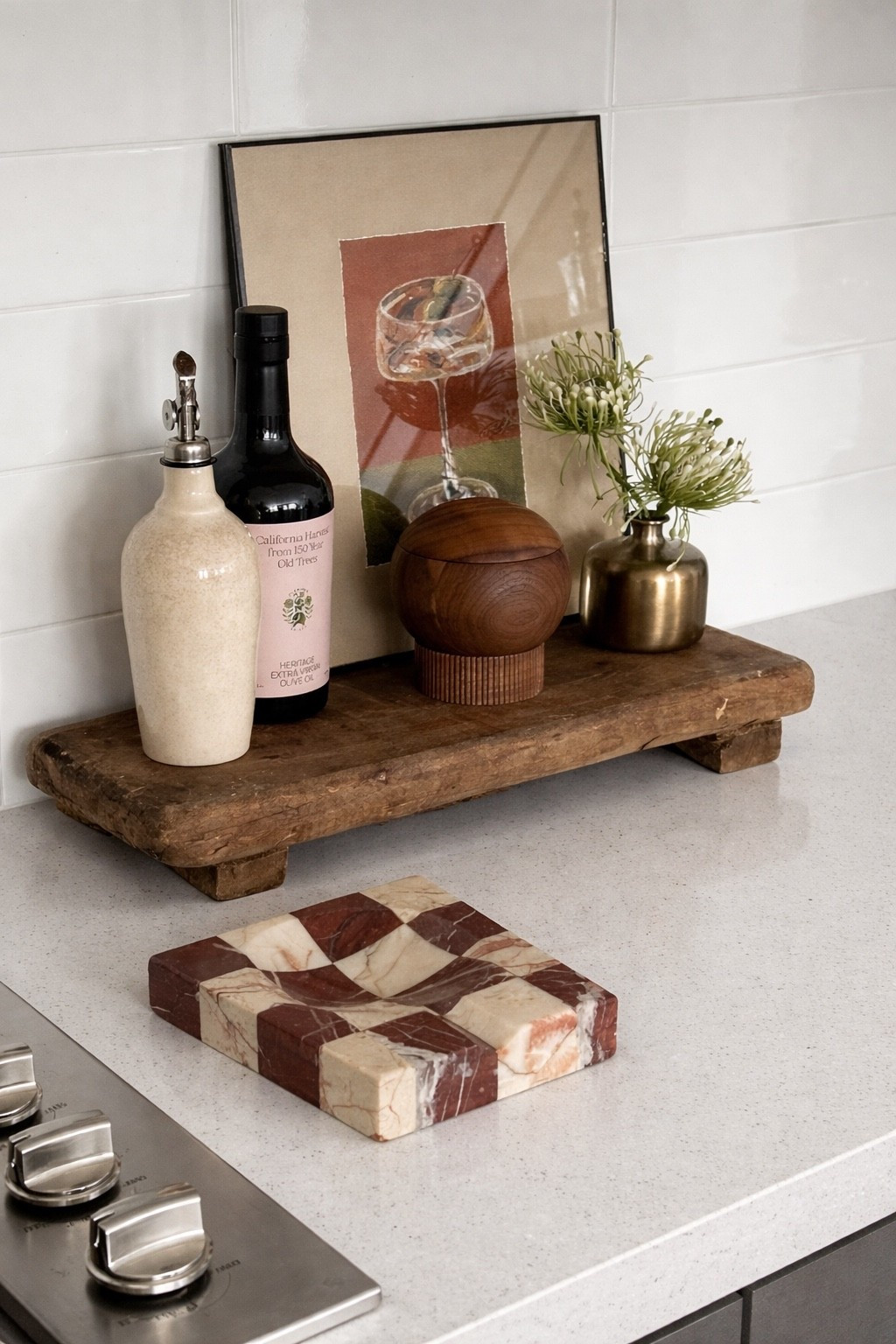 Modern kitchen countertop styling with neutral decor, featuring a white quartz counter, wooden riser tray, olive oil bottles, brass vase, and marble checkerboard trivet. Minimalist kitchen aesthetic with warm earthy tones and clean lines, perfect for contemporary home decor inspiration, kitchen organization, and styling ideas. Ideal for small kitchen upgrades, luxury minimal interiors, and Pinterest-worthy kitchen setups.

#LTKHome