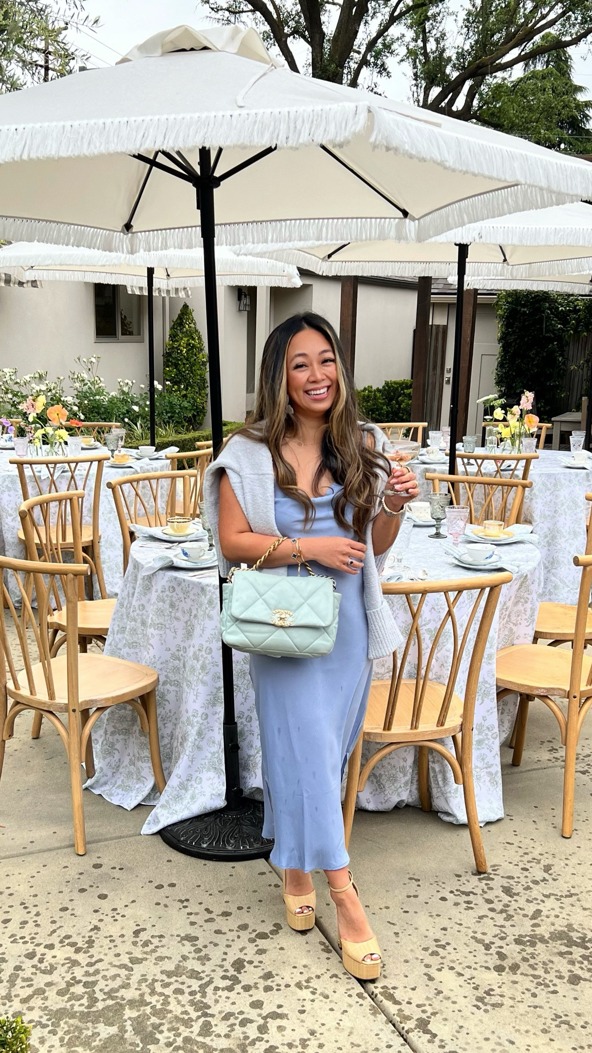 Melllypoo is wearing a light blue periwinkle slip satin silk dress with a cozy sweater around the shoulders paired with platform raffia sandal heels  Spring Afternoon Tea Garden Party

#LTKSeasonal #LTKparties #LTKshoecrush