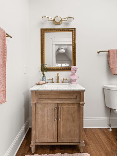 Perfect pops of pink in the bathroom carry the accent color through without it being overwhelming .

#LTKhome