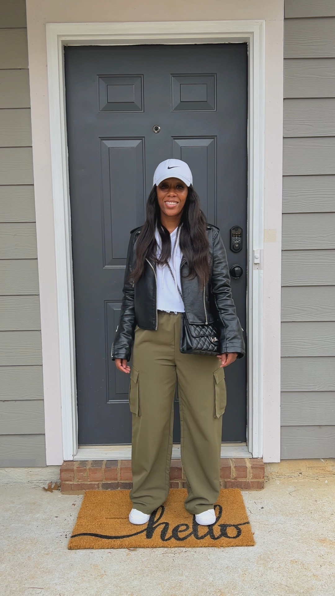 How to style a black faux leather jacket with a white cropped hoodie, green wide leg cargo pants, white Nike hat, black crossbody bag, and Nike Blazer Mid 77 sneakers

#LTKFindsUnder100 #LTKStyleTip #LTKSeasonal