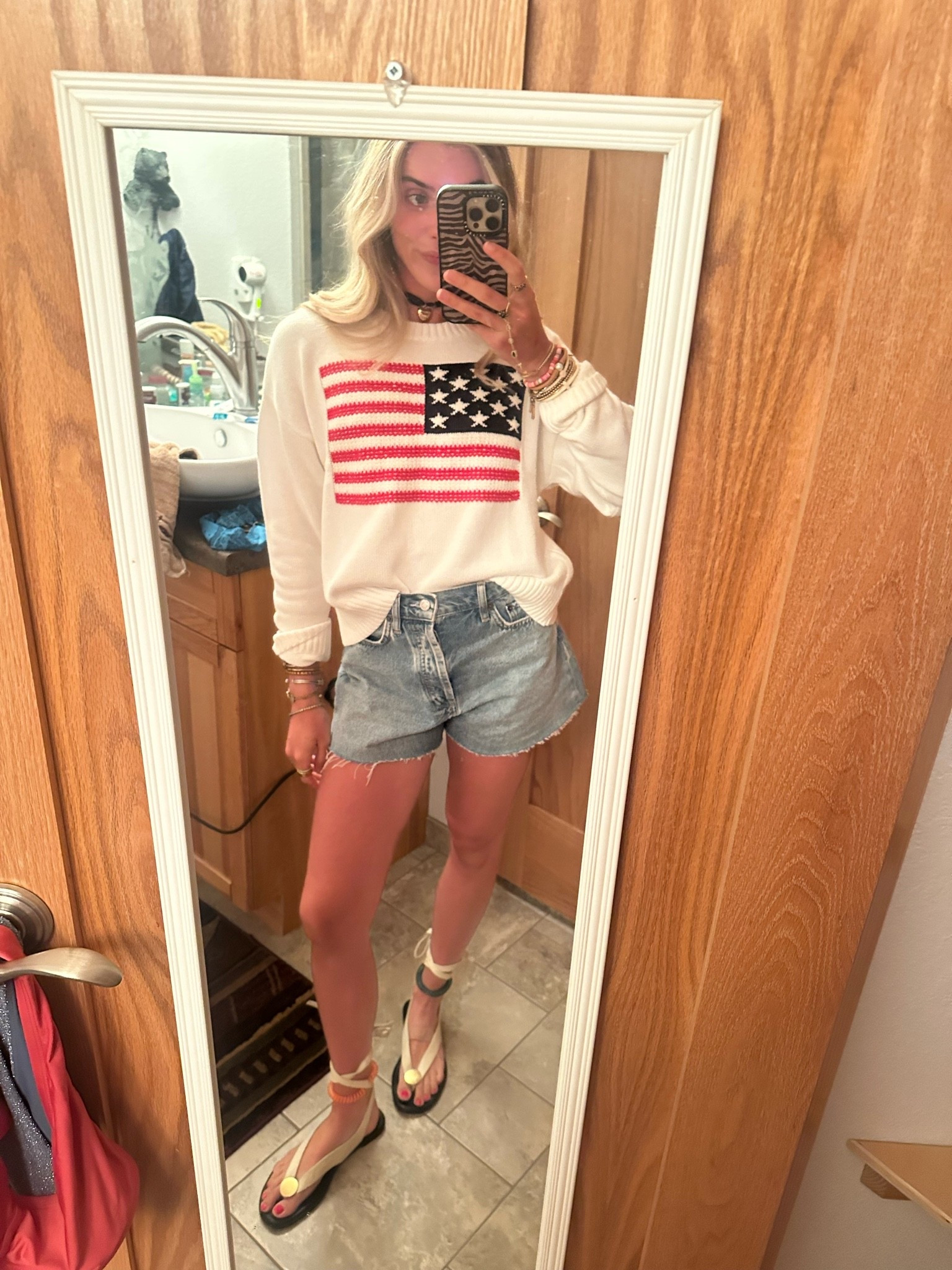 July 4th outfit! My @oldnavy American flag sweater I sized up to size small to make it baggy. My favorite denim shorts @nuuds size 24. My wrap shoes are amazon and my bikini underneath is Tiger Mist.

#LTKootd #LTKSeasonal #LTKdayinmylife
