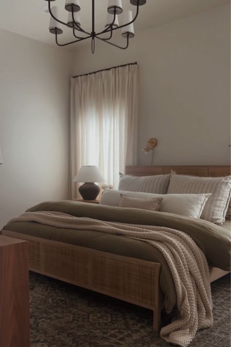 Primary bedroom, linen curtains, pinch pleat drapes, wood bed frame, olive bedding, bed pillows, chandelier, moody bedroom

#LTKhome #LTKstyletip