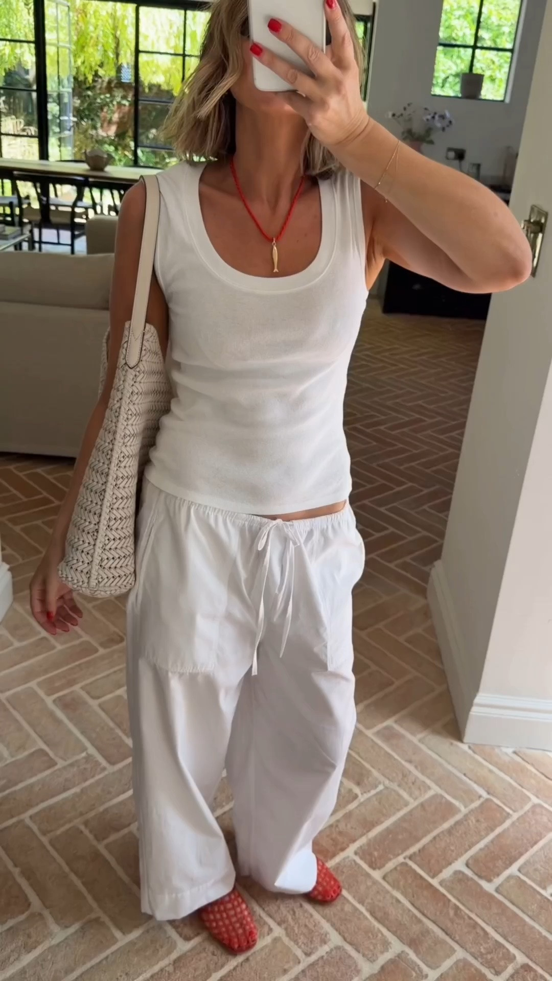 All white and a pop of red ❤️ casual outfit | vest top | jelly shoes | white trousers

#LTKuk #LTKsummer #LTKeurope