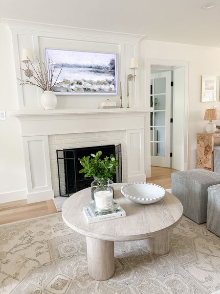 Living room, neutral home, round white washed / light wood coffee table, neutral beige and ivory wool rug, ottoman, fireplace mantle styling, Frame TV art

#LTKhome #LTKFind #LTKstyletip