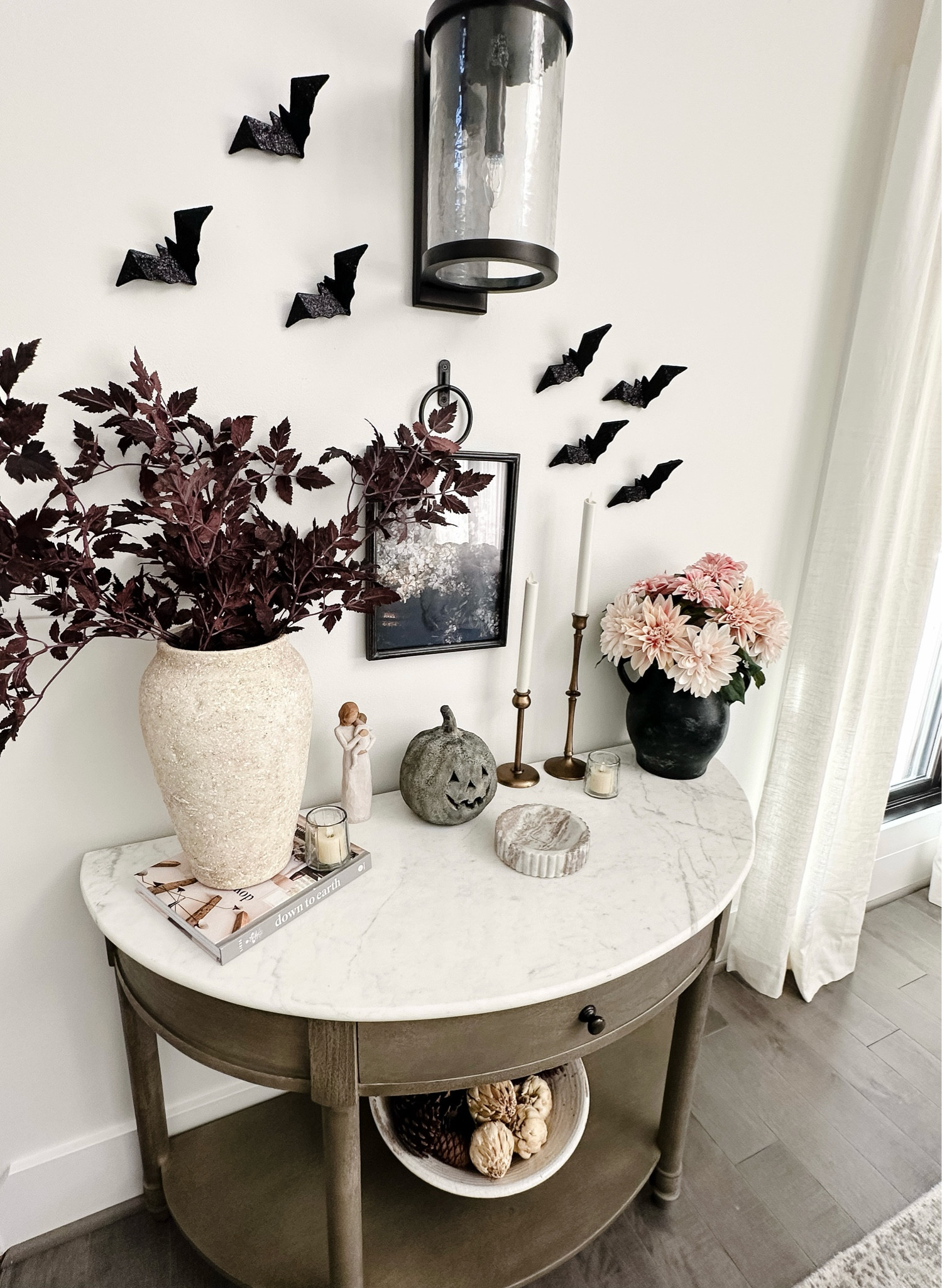 Adding some bats and a jack o lantern took this fall decorated console and made it spooky! 👻🦇🎃 

I love the versatility of these plum stems. Not only are they beautiful in the fall, but they add the perfect touch for Halloween! 

The jack o lantern is the black terracotta from pottery barn. I was able to grab this size this year before they completely sold out! Will be grabbing more next year! 

Spooky chic Halloween | pottery barn terracotta jack o lantern | a floral plum stems | Kirklands Halloween | kirklands glitter bats | bat Halloween decor | Halloween inspo | Halloween interior design | 

#LTKhome #LTKSeasonal #LTKHalloween