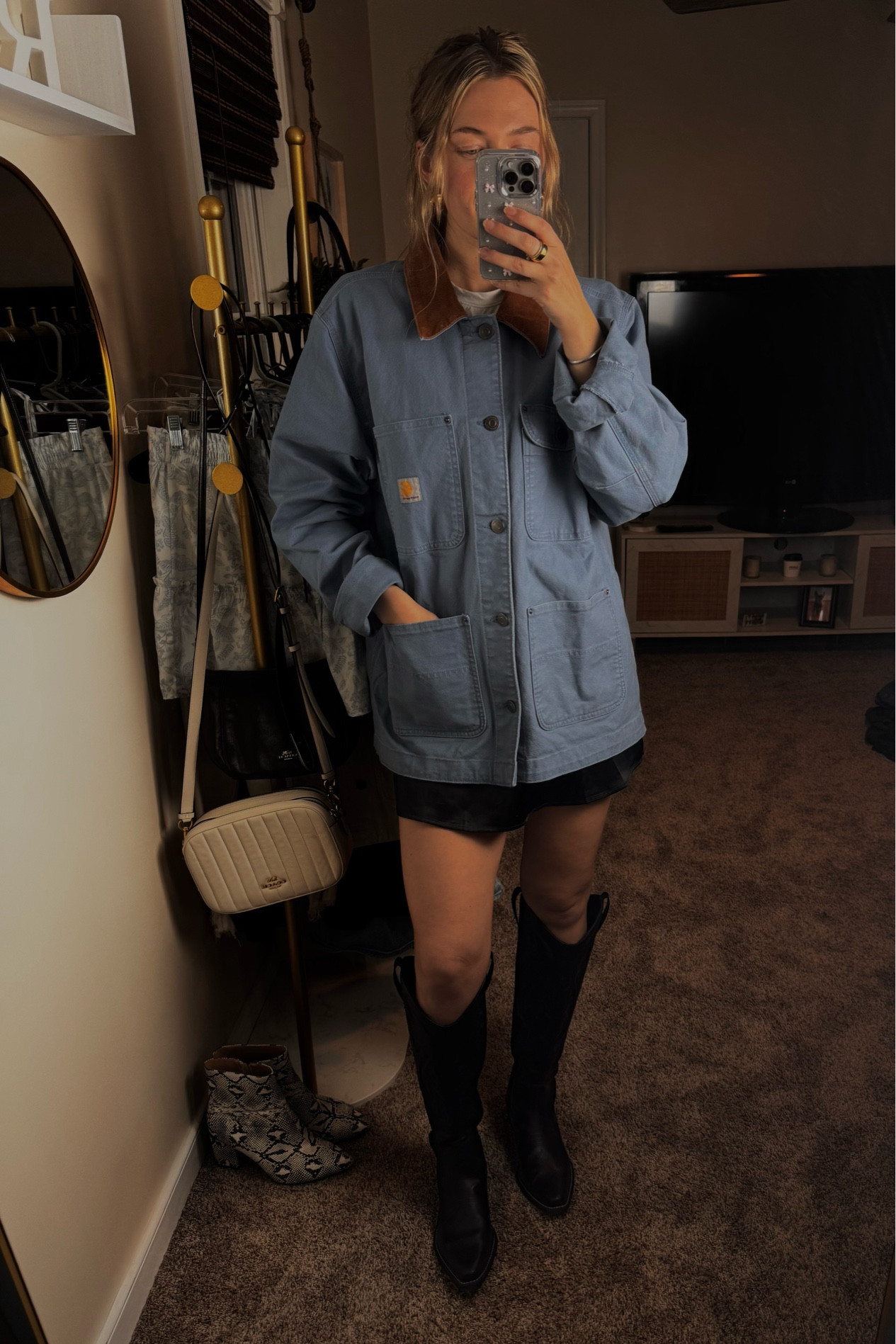 Transform your winter wardrobe with this stylish layered look! ❄️ The denim Carhartt chore coat adds an edgy twist, while the classic white tee keeps things fresh and simple. Pair it with a chic black mini skirt for a bold contrast, and elevate the whole look with tall black cowboy boots for that perfect mix of rugged and refined. 🤠 Whether you’re out for a casual day or grabbing lunch with friends, this outfit is all about comfort, style, and confidence. Shop these must-have pieces now and create your perfect winter outfit! 🛍️ #WinterStyle #CarharttChoreCoat #BlackMiniSkirt #CowboyBoots #CasualChic #LTKFinds #LayeredLook #DenimVibes #ChicAndCozy 

#LTKStyleTip #LTKSaleAlert #LTKShoeCrush