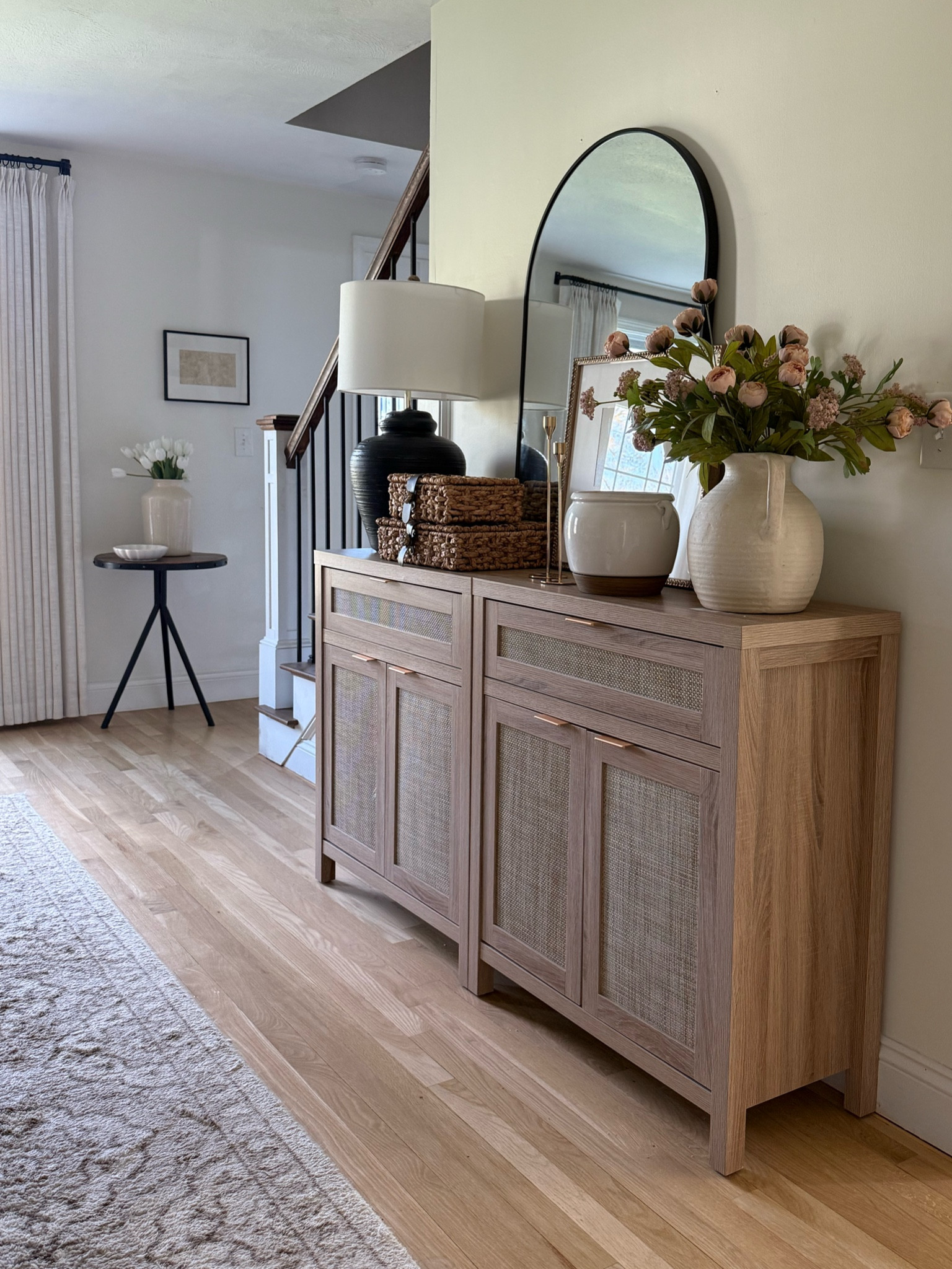 I have two of these storage cabinets pushed together and they are so great for lots of storage. I have this in my dining room and I can keep napkins and extra silverware and plates and platters here styling it with a mirror table lamp, full stems, of course in my favorite woven storage boxes for that texture!

#LTKHome