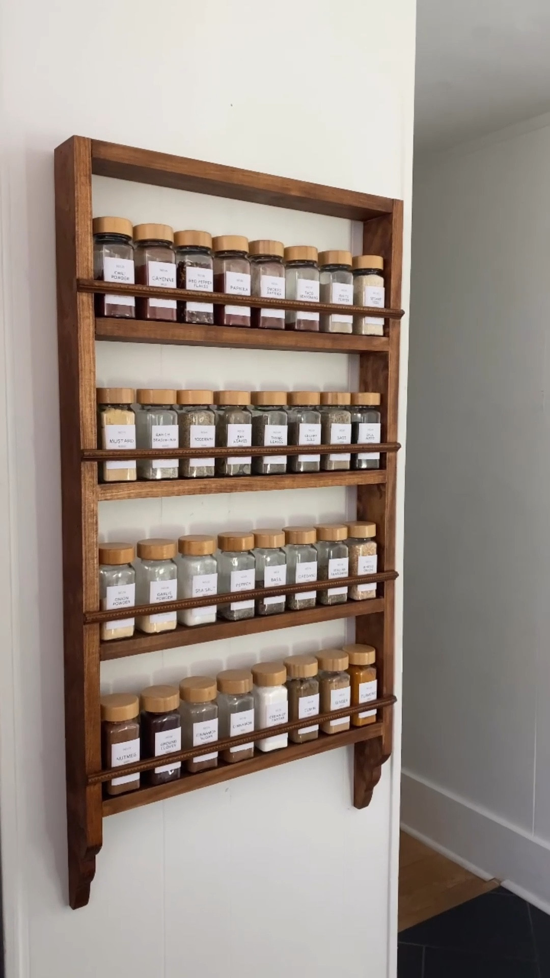 the best DIY home project we’ve ever done! Now I have the vintage inspired cottagecore spice rack of my dreams.

For the sides:
(1) 1x3 cut into (2) 35” pieces - scallops cut with a jigsaw starting 4” from the bottom of the board

For the shelves and top:
(1) 1x3 cut into (5) 17” pieces - 6.5” of space between the bottom of one shelf and the top of the next

For the trim:
(4) 18.5” long pieces tacked with the bottom of the trim sitting 1” above the top of the shelf.

**measurements were created for the specific set of spice jars tagged in this post!**

So simple to put together! Hang with an anchor/screw combo and you’re good to go!

#LTKSaleAlert #LTKHome