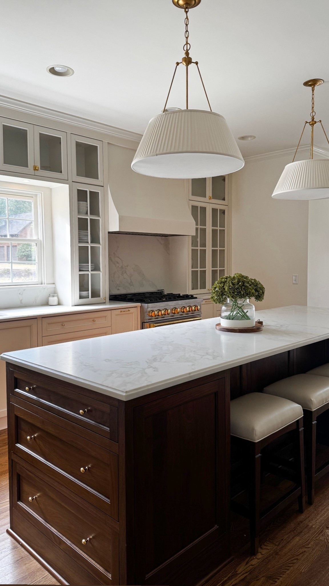 Kitchen sneak peek! Classic kitchen design. I can’t wait to add more color and southern style with accessories soon. Pleated pendants, walnut island, walnut counter stools, unlacquered brass hardware 

#LTKStyleTip #LTKHome