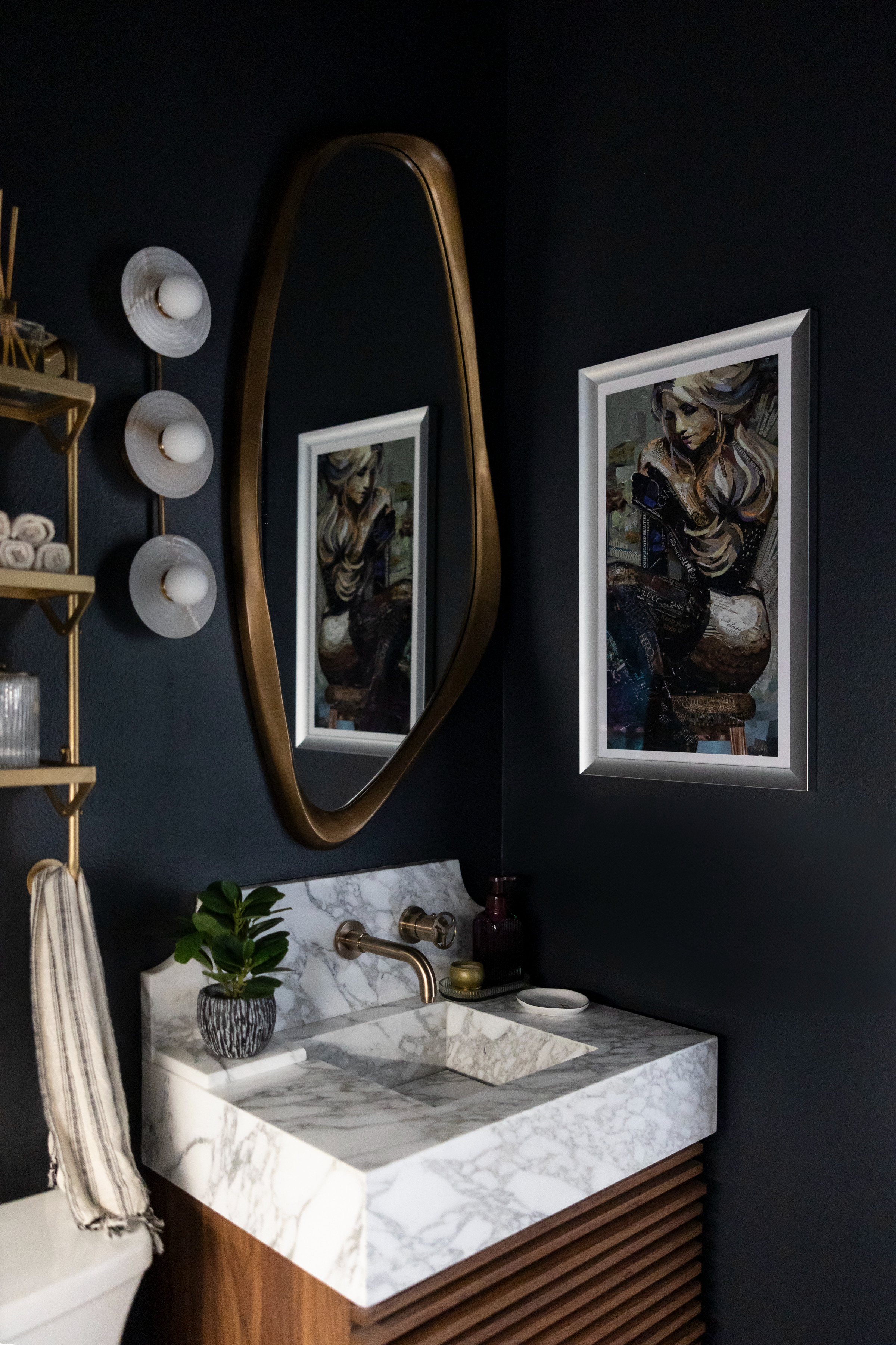 We went bold with deep charcoal walls, warm brass accents, and an integrated marble sink to make this small bathroom feel like a luxurious escape. The asymmetrical mirror adds movement while curated art brings in a personal touch✨

#InteriorDesignLovers #SmallSpaceBigStyle #DarkAndMoodyDecor 

 #LTKHome #LTKStyleTip