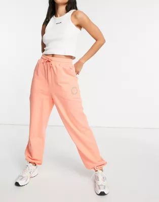 ASOS Weekend Collective oversized sweatpants with embroidered logo in coral | ASOS (Global)