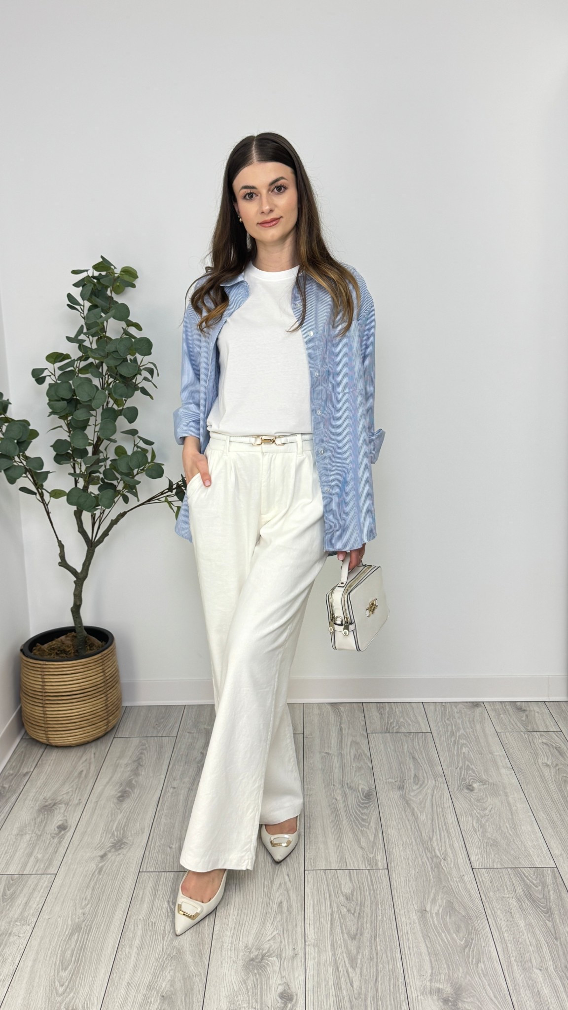 White wide-leg trousers, white T-shirt, blue striped shirt, white purse, white ballerina flats, white belt. A breezy, polished combo perfect for effortless elegance 🤍🩵 #IlaStylesDiary 

#LTKworkwear #LTKspring #LTKeurope