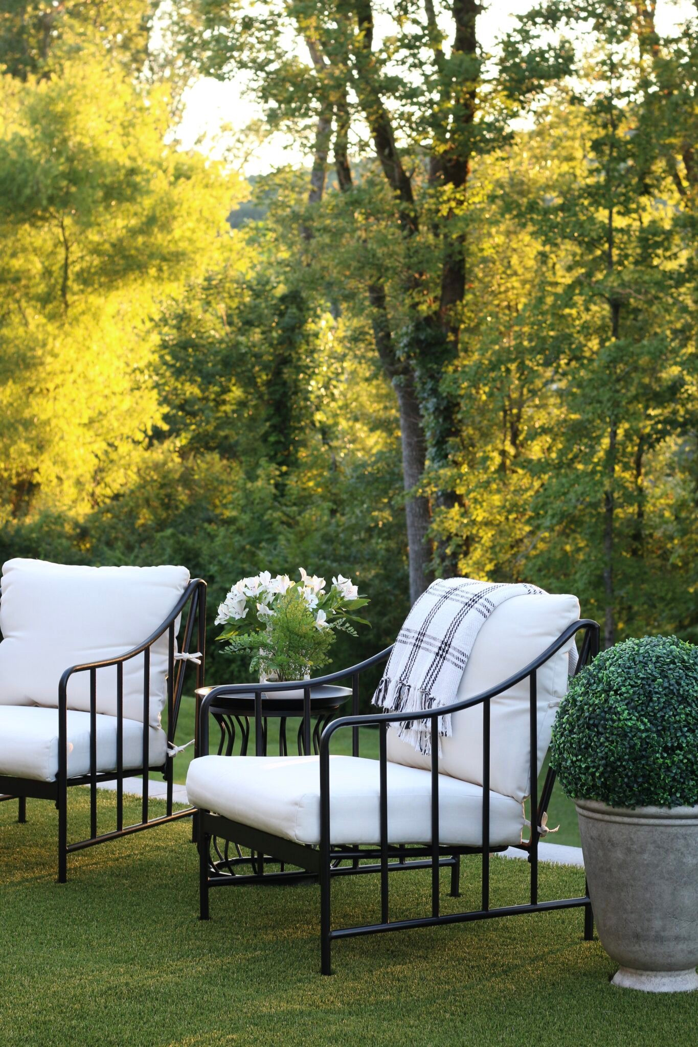 We adore these chairs! They still look beautiful two years later. And the entire set is $300. They sell out every spring. The planters and topiaries are super cute, too. 