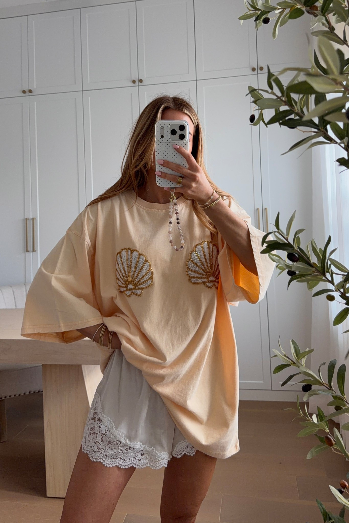 wearing an xs in this seashell tee! runs very oversized. the details are so pretty in personn