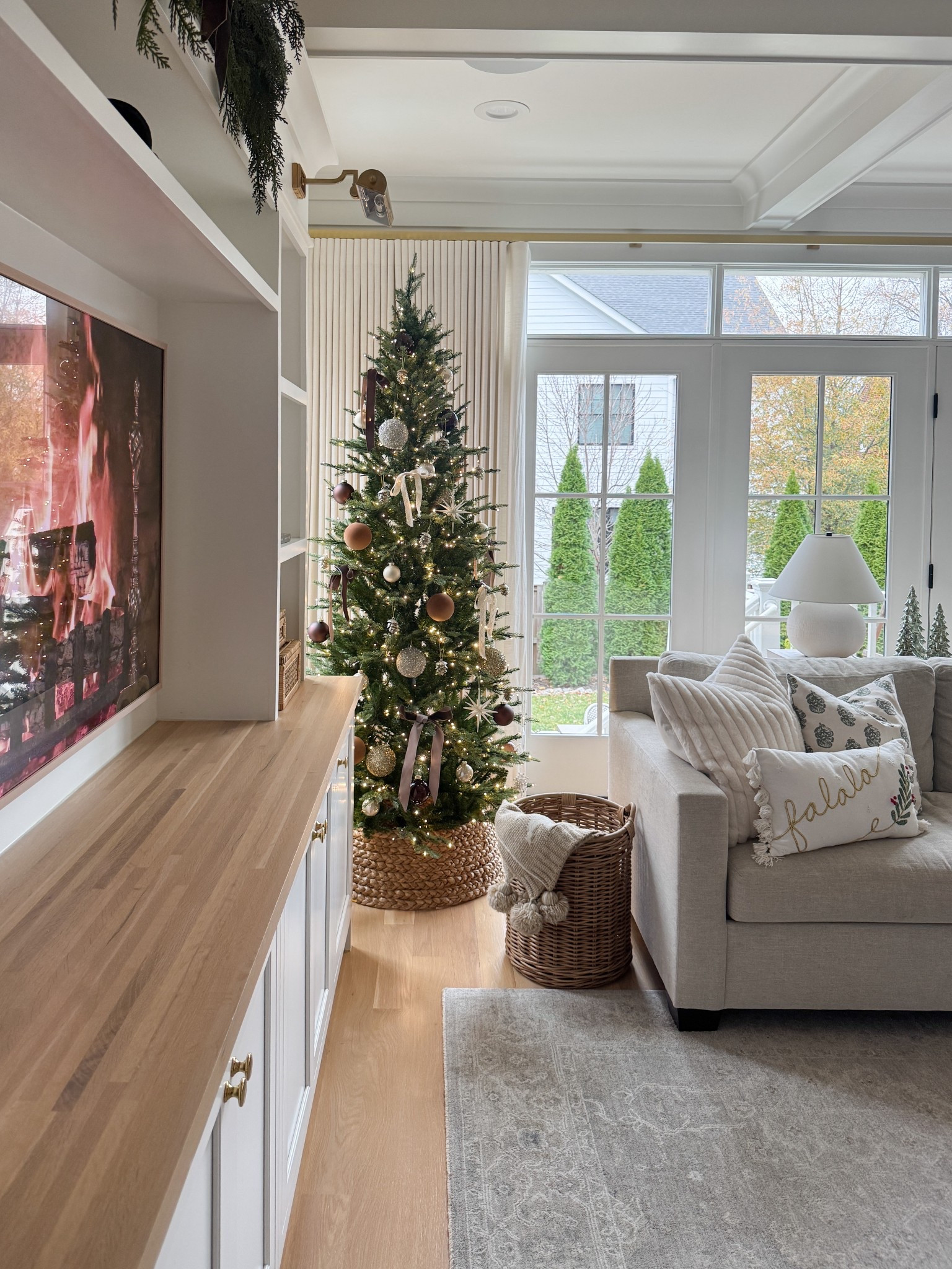 Our slim Christmas tree is the perfect base — layered with brown, ivory, and soft green accents for that warm, curated look. I mixed in Amazon pillow covers, woven textures, and a classic tree collar for a Pottery Barn–inspired moment… without the price tag.

#LTKHome #LTKSeasonal #LTKHoliday