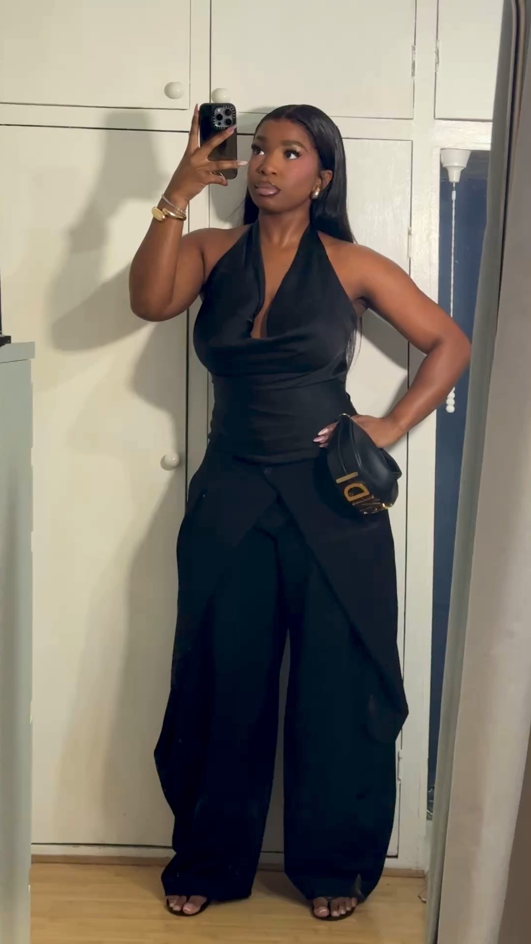 Black satin halterneck top and black trousers

#LTKluxury #LTKspring #LTKdatenight