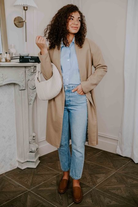 Style this spring outfit with neutral tones: pair a light wash pair of jeans with a tan coat or cardigan, worn over a blue button-down shirt. Add a statement handbag and leather loafers to finish your look.

#LTKSeasonal #LTKstyletip #LTKworkwear