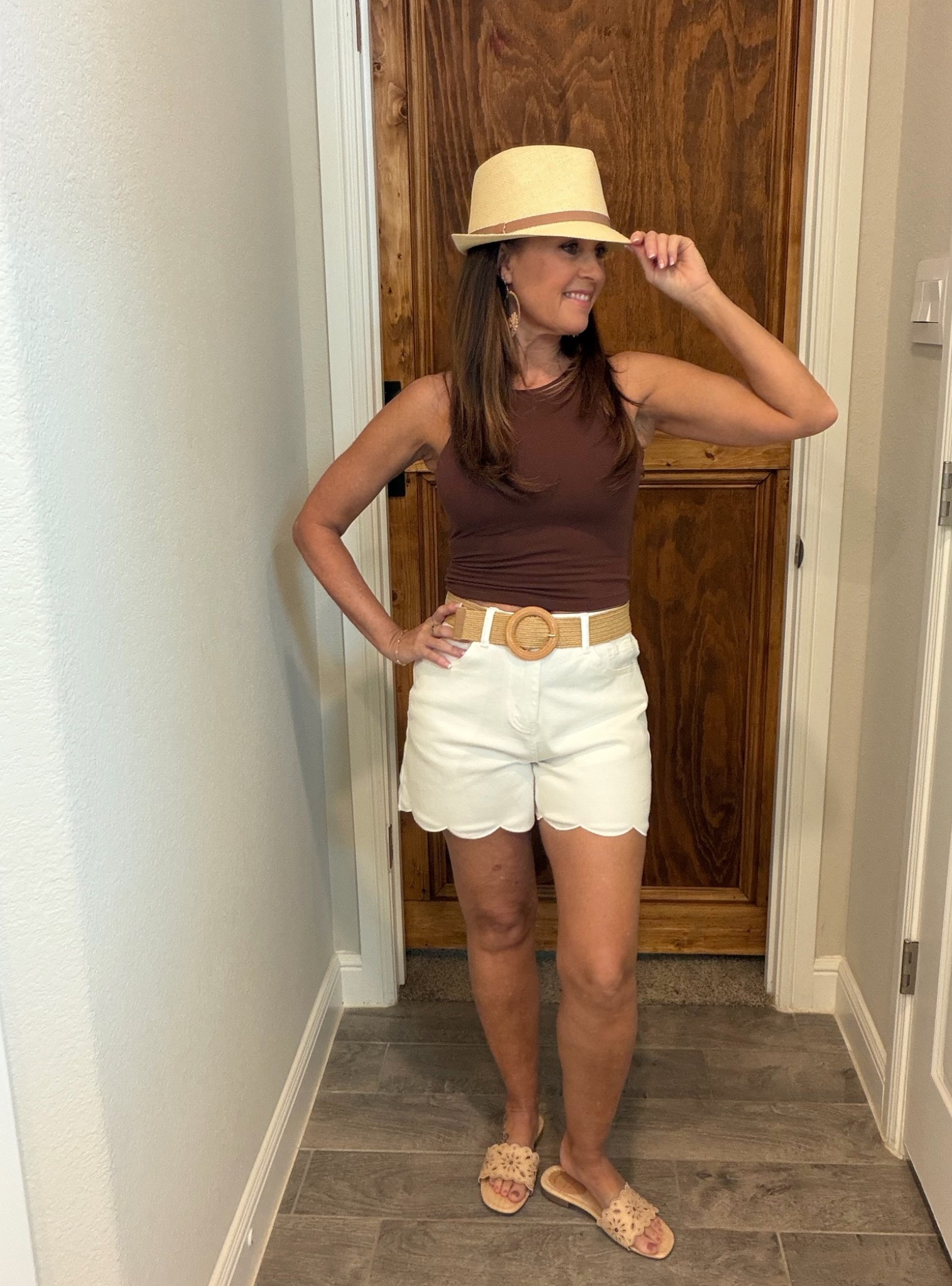Summer outfit inspiration for travel or the beach - white shorts, tanks, raffia accessories

#LTKootd #LTKSeasonal #LTKOver40