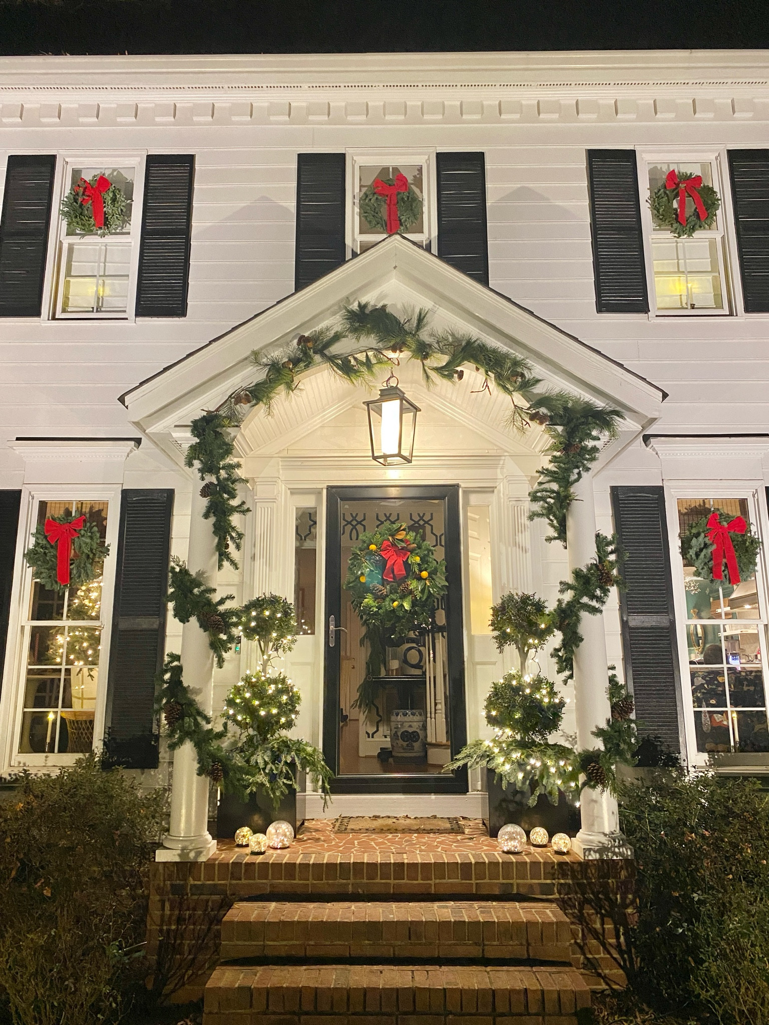 Exterior Christmas decorations 

Topiary, wreath, garland, red ribbon, battery window candles

#LTKHoliday #LTKHome #LTKSeasonal
