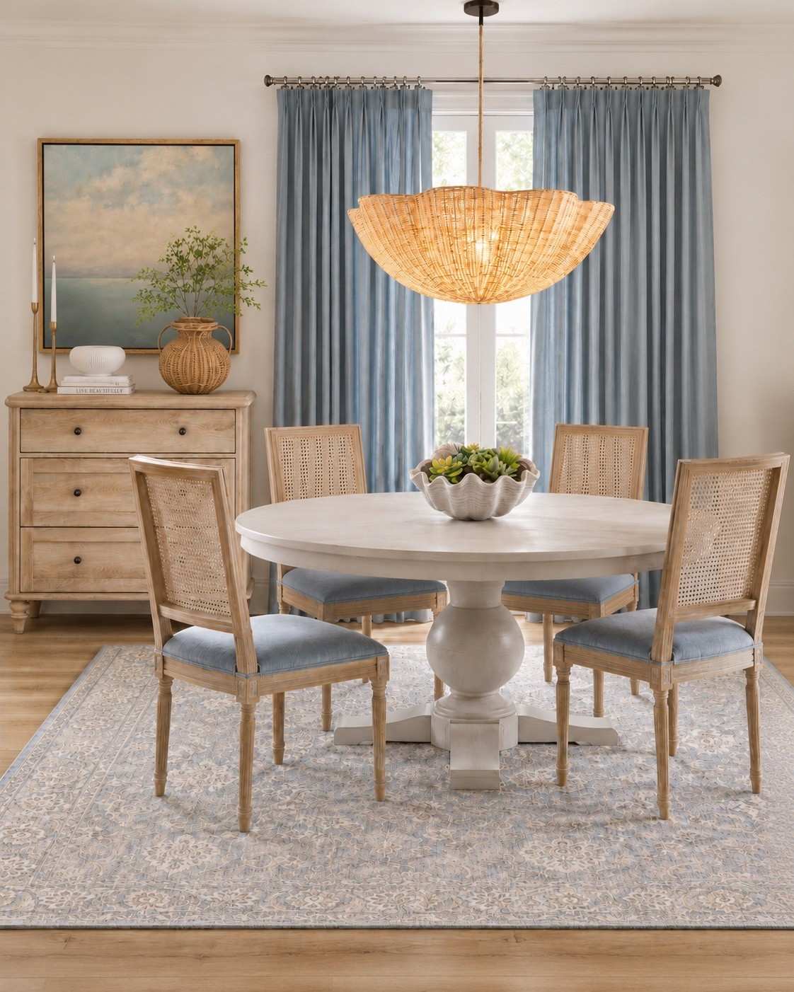 Soft coastal dining room with calm blues and light wood tones.

I love how the pale blue curtains, woven textures, cane chairs, and classic round table all work together to give this space that airy, elevated coastal feel without going too theme-y. The mix of natural wood, rattan, soft blues, and traditional pattern keeps it timeless instead of trendy.

Everything is linked below so you can recreate the look or pull a few pieces into your own dining room.

#CoastalDecor #DiningRoomDecor #DesignerLooksForLess

#LTKHome