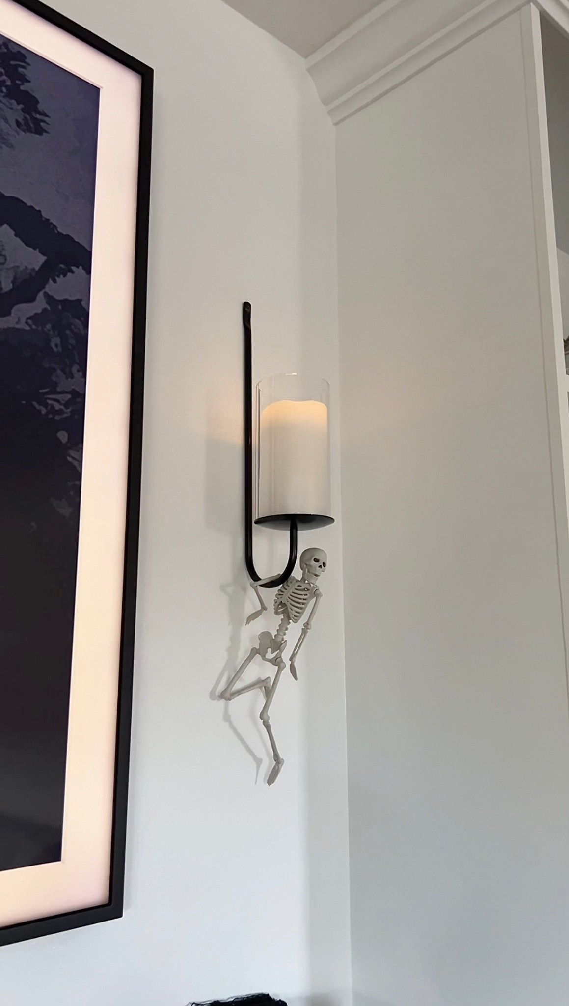 Little skeletons hanging from my sconces made my living room look even more spooky 💀 

#LTKSeasonal #LTKHome