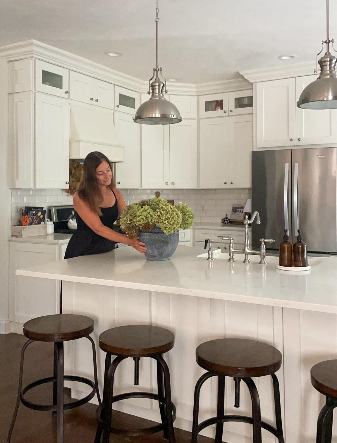 Adding in a large planter or pot to a kitchen island adds beauty and texture.  

Kitchen island.  Bar stools adjustable.  Industrial Target bar stools.  Bridge faucet.  Whirlpool appliances.  Industrial kitchen pendant lights.  

#LTKFamily #LTKHome #LTKSeasonal
