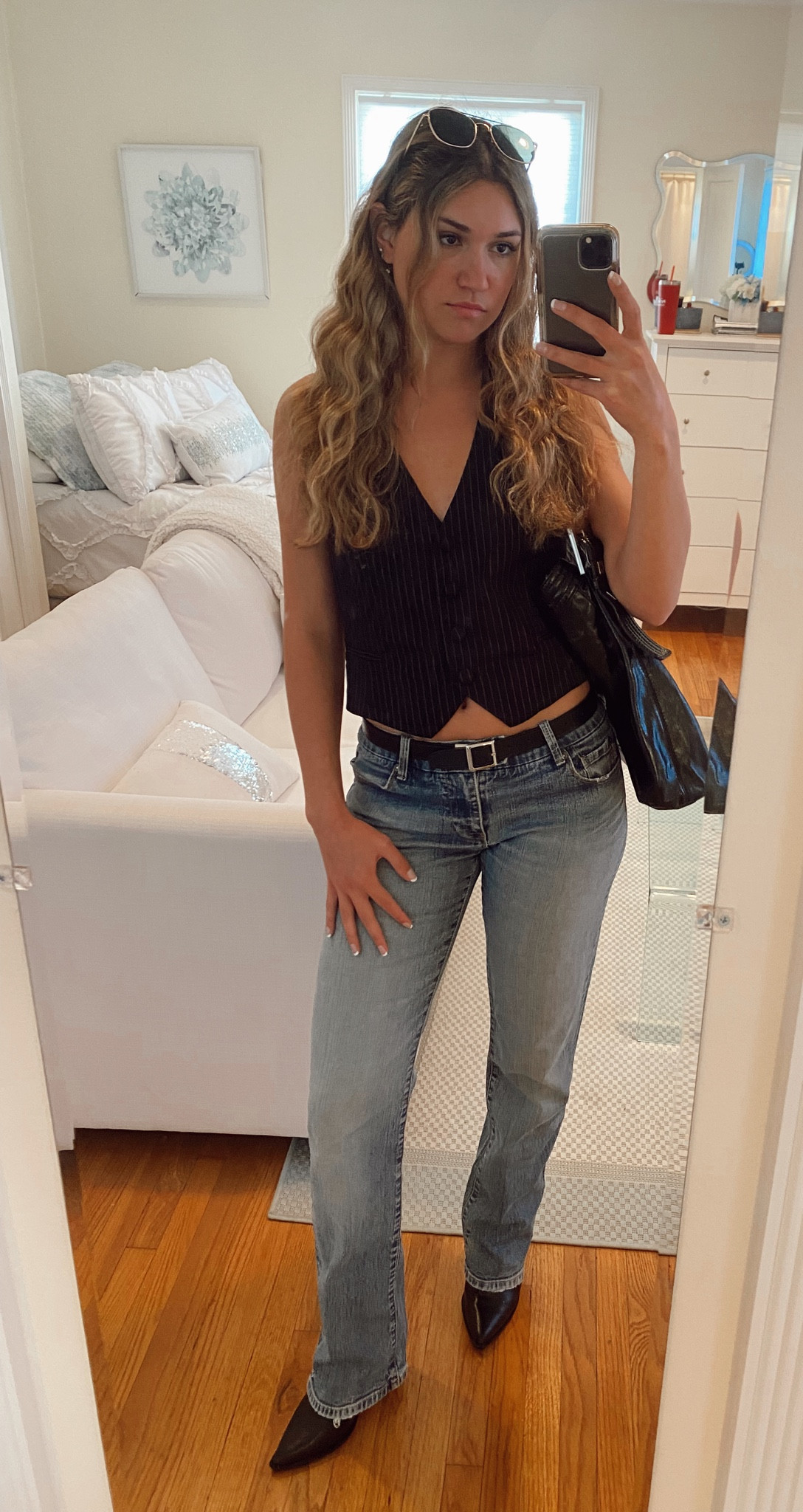 Trendy spring outfit! Low rise jeans, vest outfit, black belt, black hobo bag, cute and casual, black accessories, black booties, boot cut jeans

#LTKFind #LTKGiftGuide #LTKSeasonal