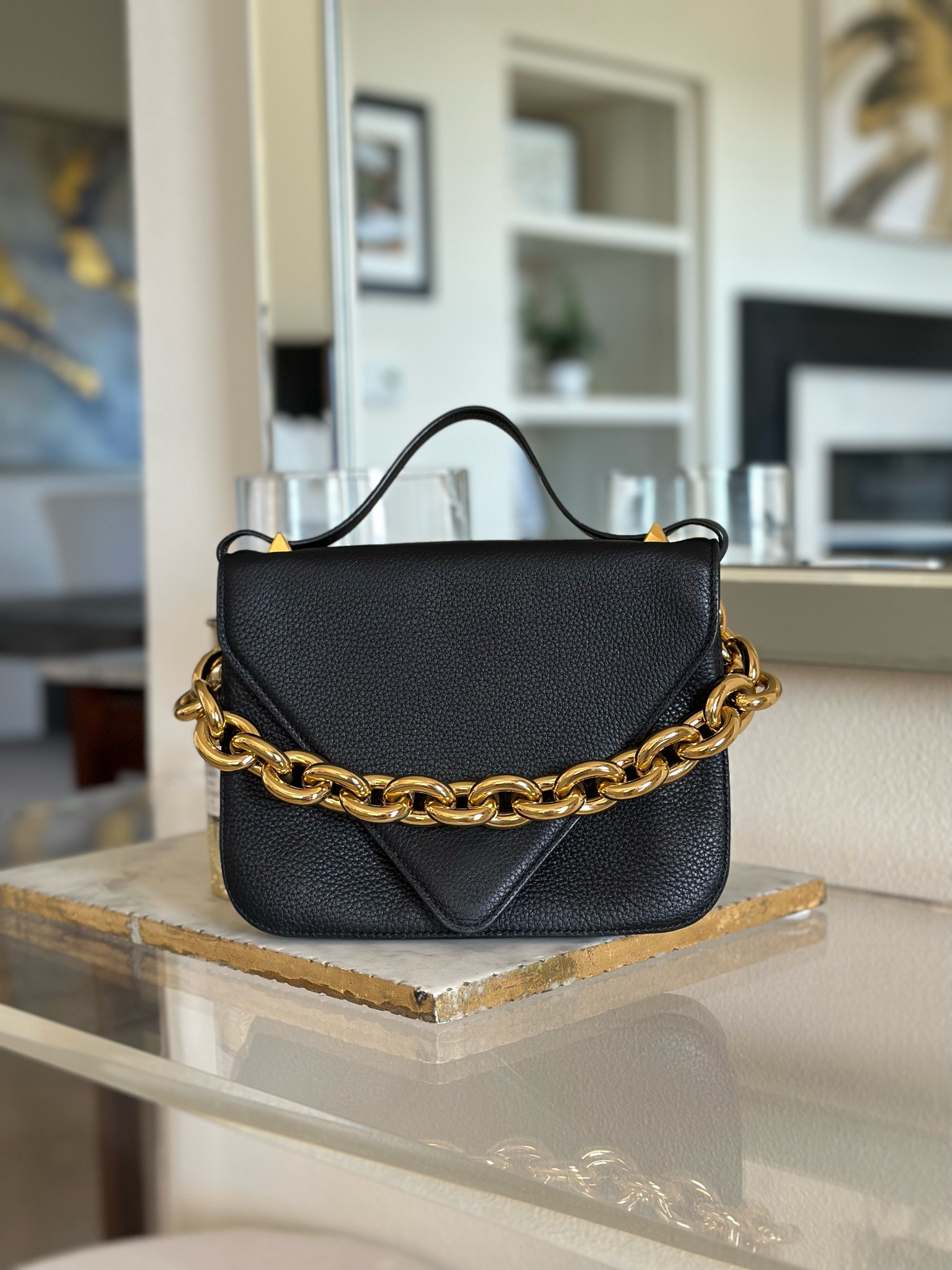 Obsessed with this uber-chic and sophisticated designer black leather handbag that also doubles as a shoulder bag or crossbody bag! It’s the perfect accessory to wear with Fall outfits, wedding guest dresses, and holiday parties. #purses #designerbags #luxurybags #luxury #designerpurse

#LTKitbag #LTKHoliday #LTKstyletip