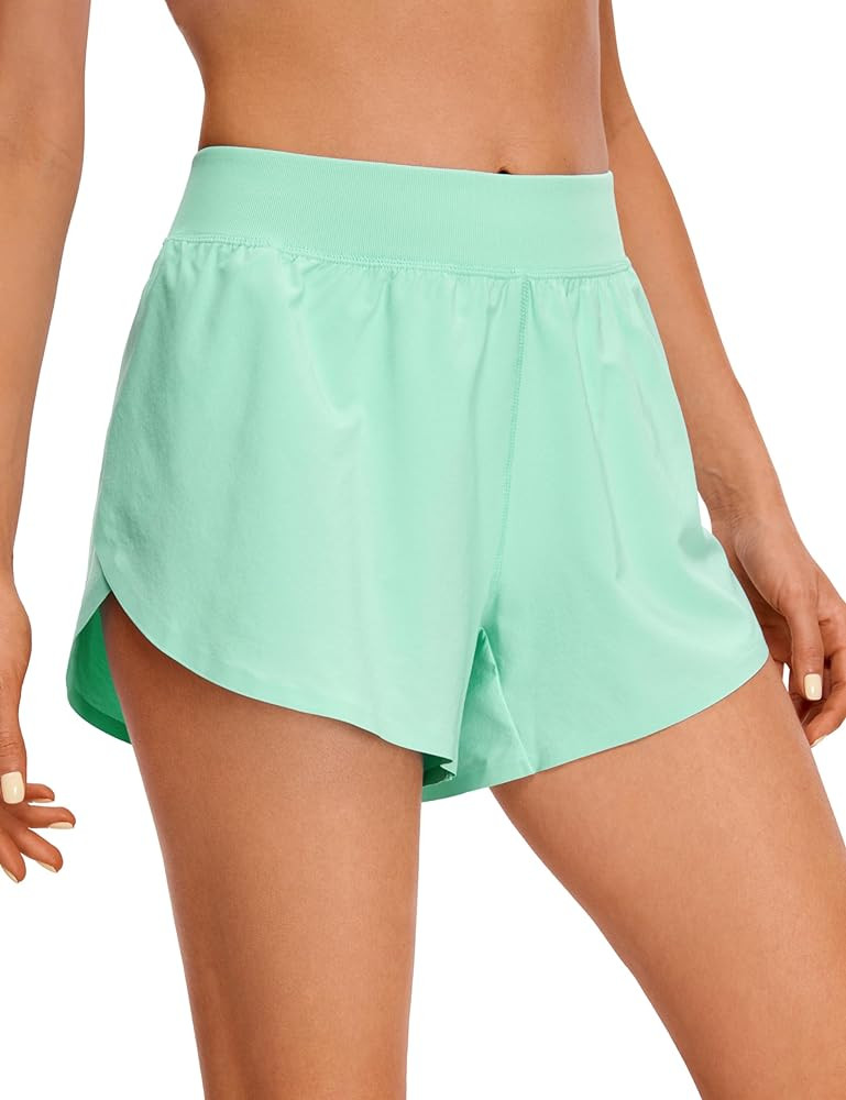 CRZ YOGA Mid Waisted Dolphin Athletic Shorts for Women Lightweight High Split Gym Workout Shorts ... | Amazon (US)